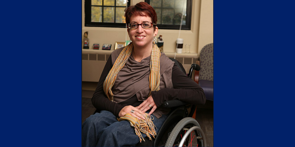 A woman in a wheelchair smiles
